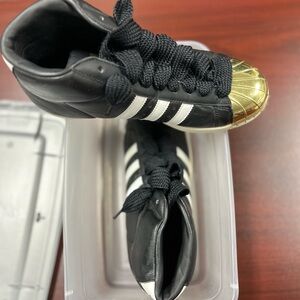 Adidas Sneakers in Black and Gold with White Stripes